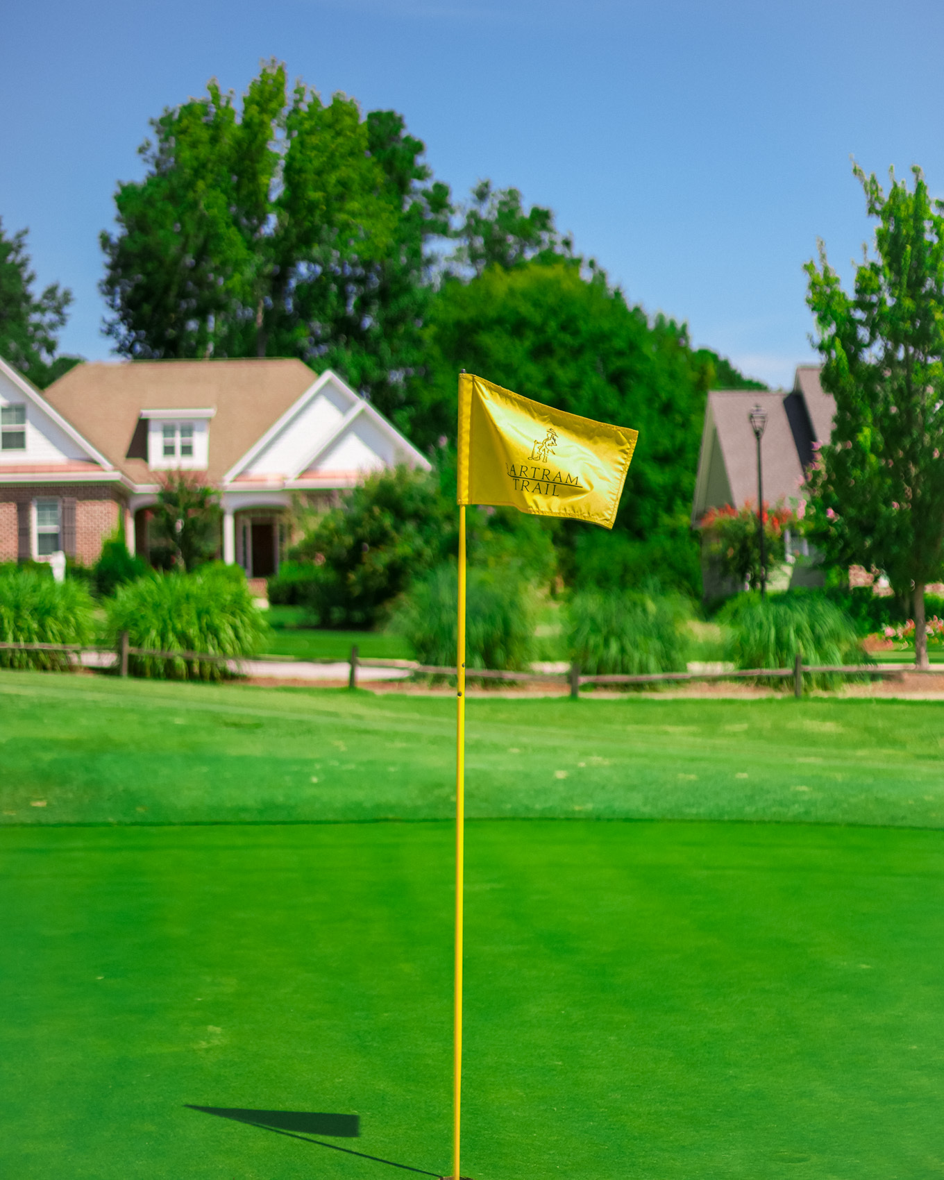 The Bartram Trail flag on a green, homes along the fairway behind